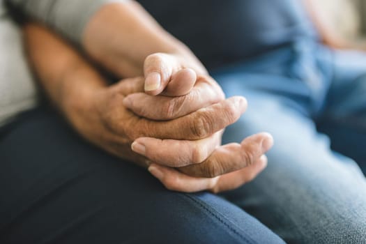 Happy romantic senior couple in love holding hands at home