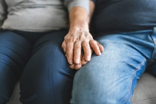 Happy romantic senior couple in love holding hands at home