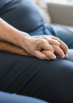 Happy romantic senior couple in love holding hands at home