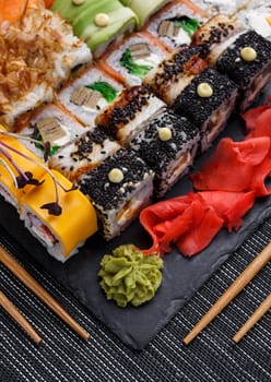 Japanese sushi food. Maki ands rolls with tuna, salmon, shrimp, crab and avocado. Top view of assorted sushi. Rainbow sushi roll, uramaki, hosomaki and nigiri.