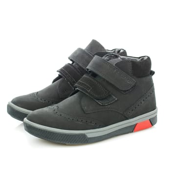 Close up of men's trendy black autumn shoes with velcro for walking. Sports style. Isolated on white background.