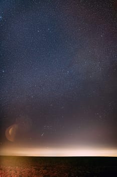 Night Starry Sky With Glowing Stars Above Countryside Landscape. Milky Way Galaxy Sky.