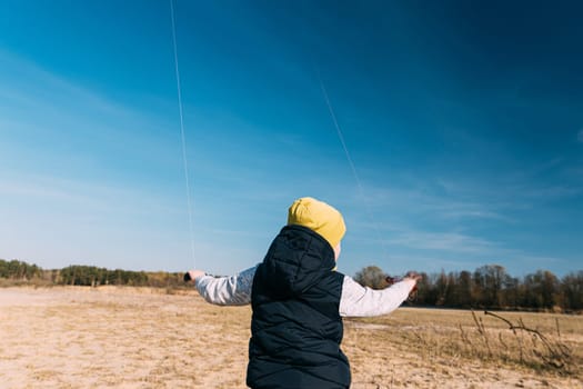 Caucasian Boy Of 6-7 Years Old Keep Two Twines From A Kites. Pleasant Activity In Fresh Air On A Sunny Spring Or Autumn Day.