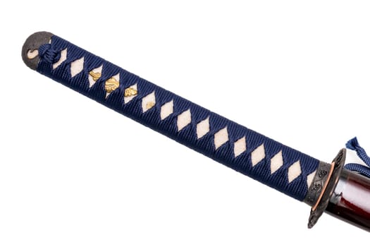 Tsuka : handle of Japanese sword wrapped by navy silk cord on white ray skin isolated in white background. Selective focus.