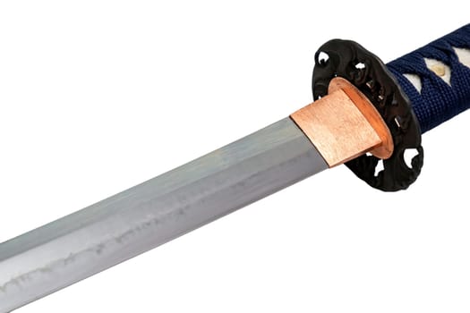 The habaki (collar) is made of polished copper. It is at the base of a Japanese sword blade with a wavy pattern on the sharp part. isolated on a white background. Selective focus.