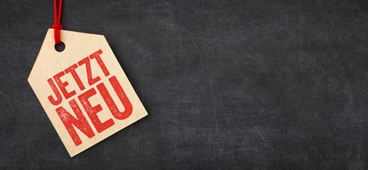 Tag on a blackboard - Now new in german - Jetzt neu