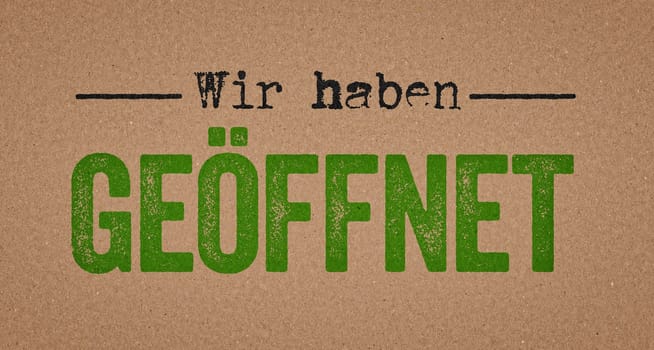 We are open in german written on a retro paper background - Wir haben geöffnet