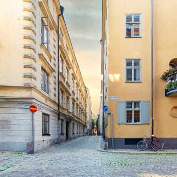 Narrow alleys located in Gamla stan, the old town of Stockholm, Sweden with old style orange houses and cobblestone streets, Stockholm, Sweden