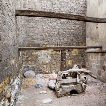 Front view of abandoned ruined ancient rotary Flour Mill used to be rotated by animal power, located at historic Ottoman era El Sehemy House, Moez Street, Islamic Cairo, Egypt