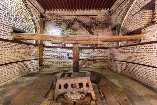 Front view of ancient rotary Flour Mill used to be rotated by animal power, known as Abu Shaheen Mill with black and red bricks wall, located next to El Amasely historic house, Rosetta city, Egypt