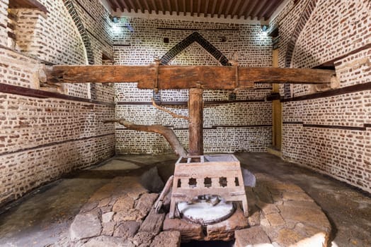 Front view of ancient rotary Flour Mill used to be rotated by animal power, known as Abu Shaheen Mill with black and red bricks wall, located next to El Amasely historic house, Rosetta city, Egypt