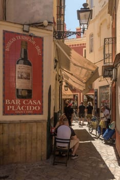 small narrow street in the historic old town of Seville, Spain