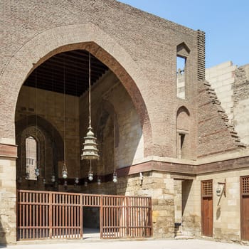 Main courtyard of public historic mosque of Sultan Al Nassir Qalawun with huge arch, Cairo, Egypt