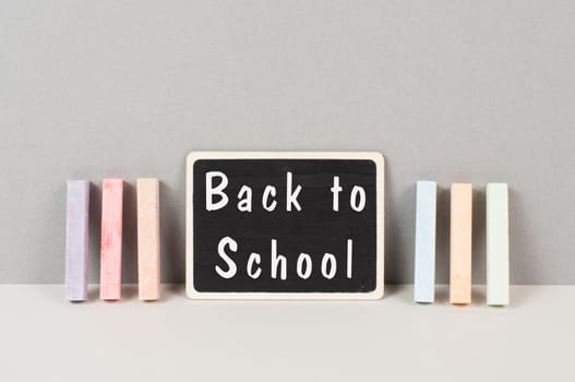 Chalkboard with the text back to school, education concept, colorful chalk
