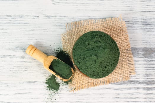 Spirulina algae powder in a bowl, alternative medicine for to detox, antioxidant food ingredients