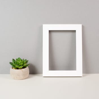 Home interior poster mock up with wooden frame, cactus in a pot, colored wall background, copy space for text and pictures