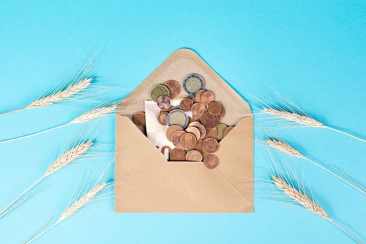 Envelope with wheat and Euro banknotes, food shortage and increasing prices, poverty through inflation