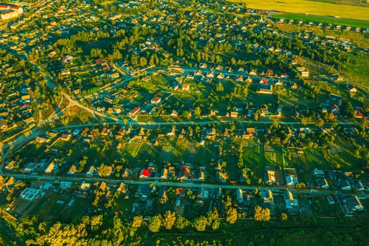 Aerial View Of Vegetable Gardens In Small Town Or Village. Skyline In Summer Evening. Village Garden Beds In Bird's-eye View.