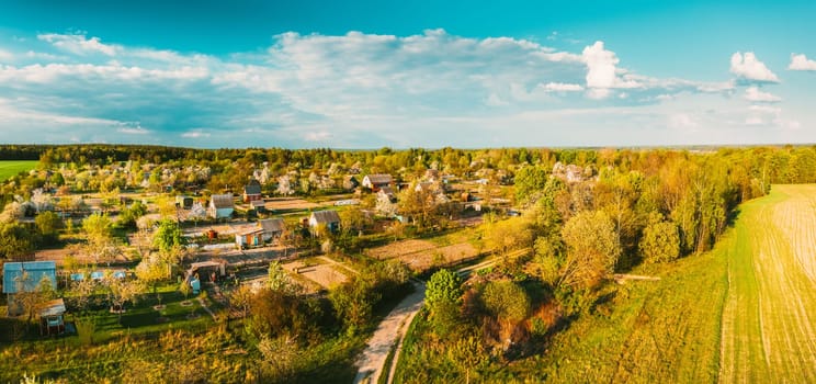 Countryside Rural Landscape With Small Village, Gardens And Green Field In Spring Summer Day. Elevated View. Panorama.