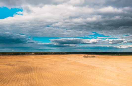 Aerial View. Amazing Natural Dramatic Sky With Rain Clouds Above Countryside Rural Field Landscape In Spring Day. Scenic Sky With Fluffy Clouds On Horizon. Beauty In Nature.