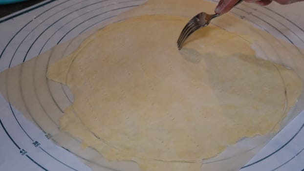 Puncturing cake by the fork on the size meter board