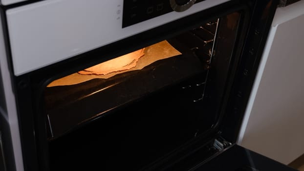 Homemade baked puff layers for napoleon cake taking off from the oven.