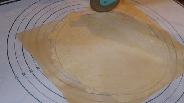 Cutting cookies with a cookie cutter on the size meter board.
