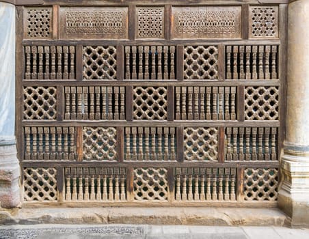Front view of interleaved wooden arabisk wall - Mashrabiya, Facade of public historic mosque of Amir Al-Maridani, Cairo, Egypt