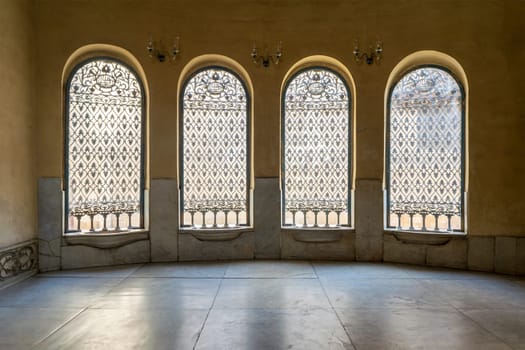 Old abandoned Ottoman era historic Soliman Agha El Silahdar Sabil public building with four windows covered by decorated iron grid, Moez Street, Cairo, Egypt