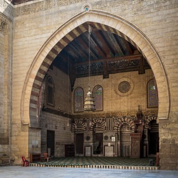 Main iwan - arch - at the courtyard of public historic Mamluk era mosque of Sultan Al Ashraf Barsbay located at Al Moez street, Old Cairo, Egypt
