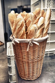 Baker slice taking fresh baked bread from oven. Manufacturing process of spanish bread