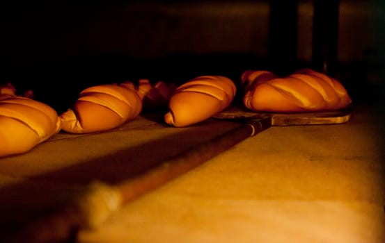 Oven inside plenty of bread. Manufacturing process of spanish bread
