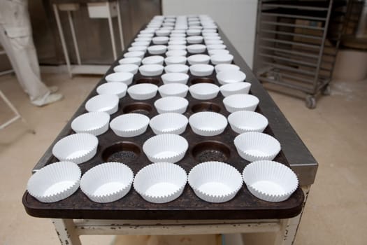 Baking cups tray. Handmade manufacturing process of spanish madeleines