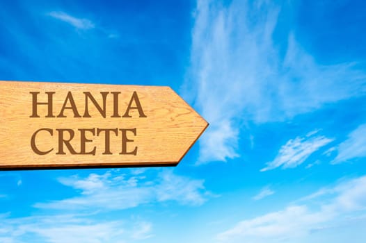 Wooden arrow sign pointing destination HANIA, GREECE against clear blue sky with copy space available. Travel destination conceptual image