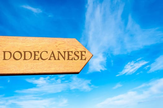Wooden arrow sign pointing destination DODECANESE, GREECE against clear blue sky with copy space available. Travel destination conceptual image