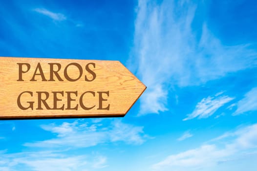 Wooden arrow sign pointing destination PAROS, GREECE against clear blue sky with copy space available. Travel destination conceptual image