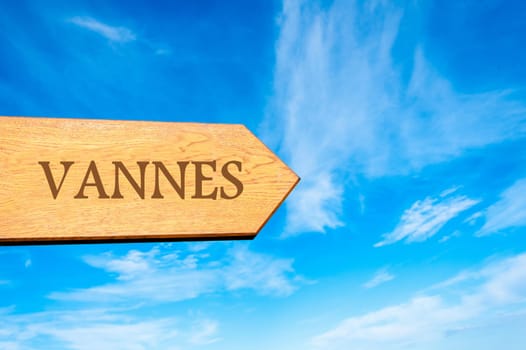 Wooden arrow sign pointing destination VANNES, FRANCE against clear blue sky with copy space available. Travel destination conceptual image