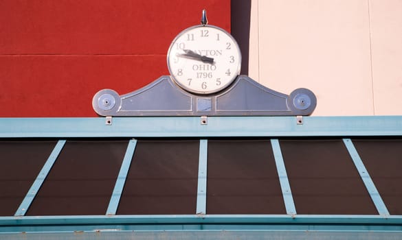 Clock on top of a bus stop bench station