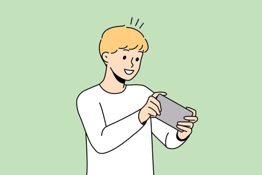 Happy boy child playing online game on cellphone. Smiling small kid have fun engaged in video games on smartphone. Modern web app. Vector illustration.