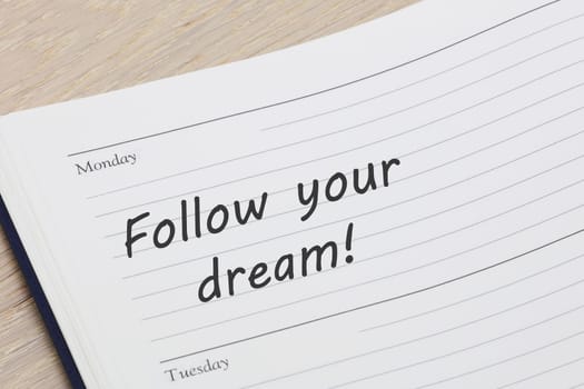 A Follow your dream diary reminder appointment open on desk