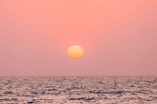 Natural Color Sunset Sunrise Sky Over Sea. Seascape With Shining Setting Sun On Sea Horizon.