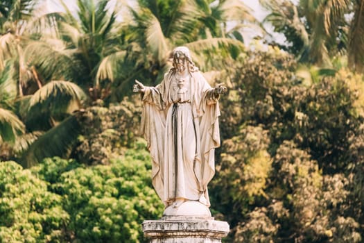 Old Goa, India. Cathedral Of St. Paul And Statue Of Jesus In Sunny Day.