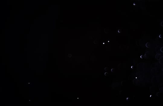 Light abstract dark bokeh christmas circle color glitter blurred black background