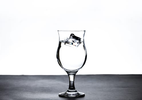 The image of pouring drinking water, into a glass, that makes one feel refreshed on blurred white background, Splashing water, Sparkling water