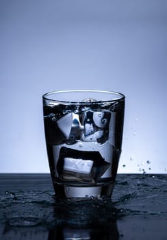 The image of pouring drinking water, into a glass, that makes one feel refreshed on blurred white background, Splashing water, Sparkling water