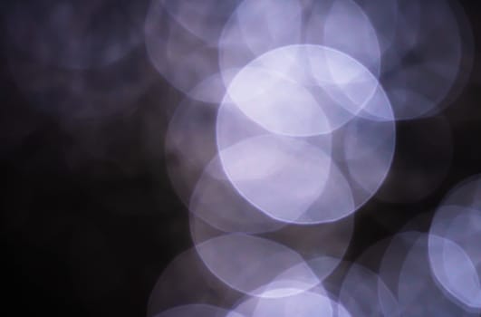 Light abstract dark bokeh christmas circle color glitter blurred black background