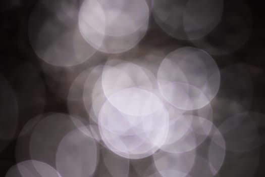 Light abstract dark bokeh christmas circle color glitter blurred black background