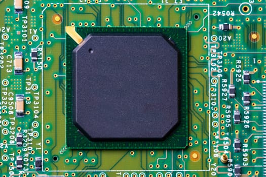 Closeup of micro processor chip on motherboard in computer. Green printed circuit board. PCB.  Computer and networking communication technology concept. Green technology background.