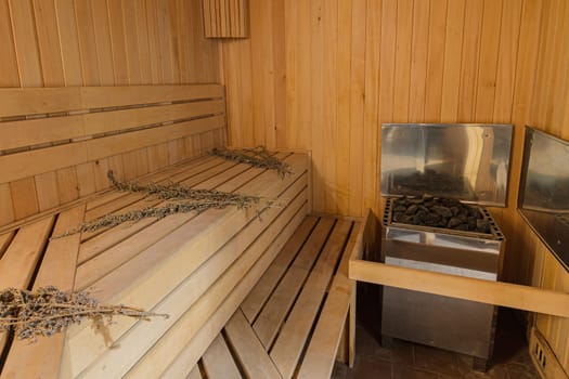 Interior of a sauna in a private house with an electric boiler