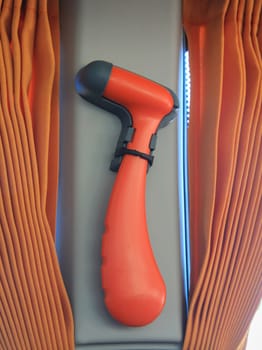 An emergency hammer, emergency hammer or glass breaking hammer in a bus.